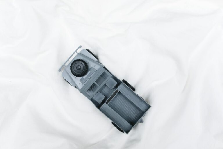 Overhead view of a grey plastic model military vehicle on a white background, ideal for hobby enthusiasts.